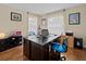 The office features a large desk, natural light, and built in shelving at 9034 Paolos Place Paolos Place, Kissimmee, FL 34747