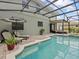 Inviting screened pool with outdoor lounge area and beautiful landscaping at 9034 Paolos Place Paolos Place, Kissimmee, FL 34747