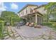 Beautiful backyard patio with stone pavers, outdoor furniture, grill, and lush landscaping at 922 N Pennsylvania Ave, Winter Park, FL 32789