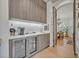 Elegant bar area featuring custom cabinetry, sleek countertops, and a built-in wine fridge, ideal for entertaining guests at 922 N Pennsylvania Ave, Winter Park, FL 32789