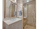 Charming bathroom featuring unique wallpaper, a modern vanity, and a glass-enclosed shower, creating a stylish and inviting space at 922 N Pennsylvania Ave, Winter Park, FL 32789