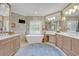Luxurious bathroom featuring dual vanities, a freestanding tub, and elegant finishes, creating a spa-like experience at 922 N Pennsylvania Ave, Winter Park, FL 32789