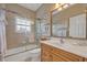 Cozy bathroom with a shower-over-tub, tiled walls, a single sink vanity, and decorative artwork at 922 N Pennsylvania Ave, Winter Park, FL 32789