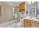 Bright bathroom featuring a shower-over-tub, light wood vanity, and neutral tile at 922 N Pennsylvania Ave, Winter Park, FL 32789