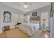 Comfortable bedroom features neutral tones, plantation shutters, iron bedframe, and accent decor at 922 N Pennsylvania Ave, Winter Park, FL 32789