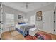 Inviting bedroom with hardwood floors, plantation shutters, and a white and blue color scheme at 922 N Pennsylvania Ave, Winter Park, FL 32789