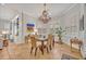 Charming dining room featuring a chandelier, plantation shutters, and seating for six guests at 922 N Pennsylvania Ave, Winter Park, FL 32789