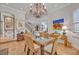 An open dining room with a glass table, views to the living room, and bright natural light at 922 N Pennsylvania Ave, Winter Park, FL 32789