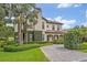 An elegant two-story home featuring lush landscaping, a circular driveway and tasteful architectural details at 922 N Pennsylvania Ave, Winter Park, FL 32789