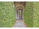 Charming front entrance with iron gate and lush greenery-covered walls at 922 N Pennsylvania Ave, Winter Park, FL 32789