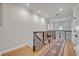 Upstairs hallway with hardwood floors, decorative accents, and natural light, creating a welcoming transition between rooms at 922 N Pennsylvania Ave, Winter Park, FL 32789