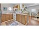 Efficient kitchen with light wood cabinets, white appliances, and a cozy breakfast nook overlooking the living area at 922 N Pennsylvania Ave, Winter Park, FL 32789