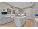 Spacious kitchen featuring a large island, modern gray cabinetry, and beautiful countertops, perfect for cooking and entertaining at 922 N Pennsylvania Ave, Winter Park, FL 32789