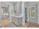 Modern laundry room with gray cabinets, countertop space, stacked washer/dryer, and a stylish rug at 922 N Pennsylvania Ave, Winter Park, FL 32789