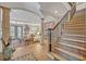Open-concept living room featuring tile floors, a staircase with iron railing, and views to the backyard at 922 N Pennsylvania Ave, Winter Park, FL 32789