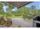Charming outdoor patio area featuring wicker furniture and a serene garden view at 922 N Pennsylvania Ave, Winter Park, FL 32789
