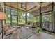 Relaxing screened porch with comfortable seating, ceiling fan, and scenic backyard views at 922 N Pennsylvania Ave, Winter Park, FL 32789