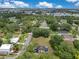 A bird's eye view captures the property's expansive yard, surrounding trees, and the neighborhood landscape at 9329 7Th Ave, Orlando, FL 32824