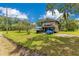 Rear exterior view of two-story house with a porch and a large yard at 9329 7Th Ave, Orlando, FL 32824