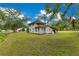 Exterior view of home on expansive lot featuring mature trees and a partially covered porch at 9329 7Th Ave, Orlando, FL 32824