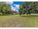 Spacious grassy yard with mature trees, perfect for outdoor activities and relaxation at 9329 7Th Ave, Orlando, FL 32824