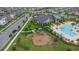 Overhead shot of a playground and community pool with nearby seating and clubhouse at 9941 Introduction Way, Orlando, FL 32832