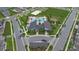 Aerial view of neighborhood clubhouse with a pool, playground, volleyball court and well maintained landscape at 9941 Introduction Way, Orlando, FL 32832