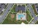 Stunning overhead view of a community pool, clubhouse, playground, and neighborhood at 9941 Introduction Way, Orlando, FL 32832