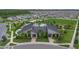 Aerial view of neighborhood clubhouse featuring a community pool, palm trees, and manicured landscaping at 9941 Introduction Way, Orlando, FL 32832