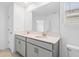 Bathroom featuring double sink vanity with large mirror and tile floor at 9941 Introduction Way, Orlando, FL 32832
