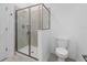 Bathroom with tile shower and glass door, neutral paint, and toilet at 9941 Introduction Way, Orlando, FL 32832