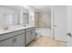 Bathroom with double vanity sinks and tub with tiled shower at 9941 Introduction Way, Orlando, FL 32832
