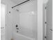 Bright bathroom with white tile surround and shower with modern fixtures at 9941 Introduction Way, Orlando, FL 32832
