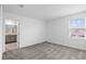 Carpeted bedroom with neutral paint, a window and en-suite bathroom at 9941 Introduction Way, Orlando, FL 32832