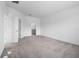 Bright bedroom with carpet, showing a view into an ensuite bathroom at 9941 Introduction Way, Orlando, FL 32832