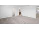 Spacious carpeted bedroom with neutral paint leading to a bathroom and closet at 9941 Introduction Way, Orlando, FL 32832