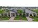 Exterior shot of a clubhouse featuring palm trees and inviting entrances at 9941 Introduction Way, Orlando, FL 32832