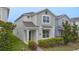 Charming two-story home featuring manicured landscaping, a welcoming entryway, and neutral color palette at 9941 Introduction Way, Orlando, FL 32832
