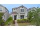 Charming two-story home with neat landscaping, a brick walkway, and a welcoming front entrance at 9941 Introduction Way, Orlando, FL 32832