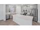 Modern kitchen with stainless steel dishwasher, ample cabinets, and a large kitchen island at 9941 Introduction Way, Orlando, FL 32832
