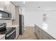Spacious modern kitchen with stainless steel appliances, white countertops, and wood-look tile flooring at 9941 Introduction Way, Orlando, FL 32832