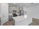 Modern kitchen with stainless steel appliances, island with white countertop, and gray cabinets at 9941 Introduction Way, Orlando, FL 32832