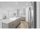 Kitchen featuring stainless steel refrigerator, kitchen island, with ample counter space at 9941 Introduction Way, Orlando, FL 32832