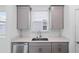 Close up of modern kitchen sink, countertops, and gray cabinets at 9941 Introduction Way, Orlando, FL 32832