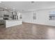 Open concept living room and kitchen with wood-look tile flooring and ample natural light at 9941 Introduction Way, Orlando, FL 32832