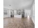 Open-concept living room showcasing a kitchen with stainless steel appliances and plenty of natural light at 9941 Introduction Way, Orlando, FL 32832