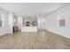 Open-concept living room featuring tile floors and a modern kitchen with stainless steel appliances at 9941 Introduction Way, Orlando, FL 32832