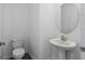 Powder room featuring a pedestal sink and toilet at 9941 Introduction Way, Orlando, FL 32832