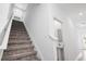 View of staircase with carpet and a half bath with pedestal sink at 9941 Introduction Way, Orlando, FL 32832