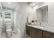 Bathroom showcasing a vanity with shaker-style cabinets and a tub with a white tiled surround at 1000 Kewannee Trl, Maitland, FL 32751